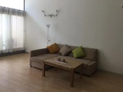 a living room with a couch and a coffee table at Loft with terrace 24m2, swimming pool and garage in Chirivella