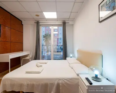 a hospital room with two beds and a window at Suites Rooms Valencia in Valencia