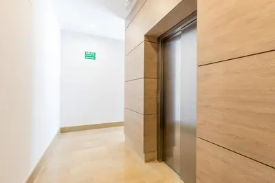 a door in a room with a wooden wall at Luxury Beach Front Apartment with Pool in Valencia