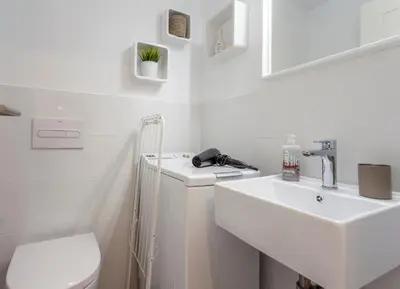 a white bathroom with a sink and a toilet at Valencia Flat Rental Malvarrosa Beach zone in Valencia