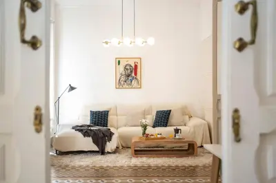a living room with a white couch and a table at SingularStays Ms Rogers in Valencia