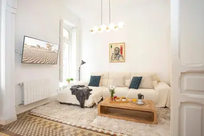 a white living room with a couch and a coffee table at SingularStays Ms Rogers in Valencia