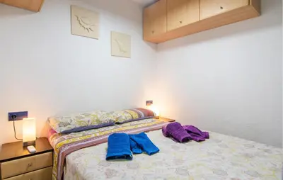 a bedroom with a bed with two towels on it at One-Bedroom Apartment In La Pobla De Farnals in Puebla de Farnals