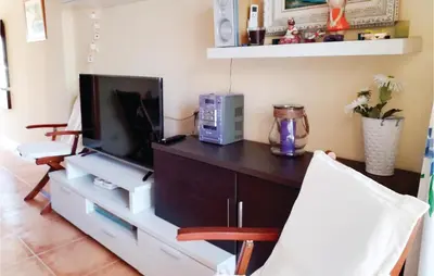 a living room with a entertainment center with a tv at 1 Bedroom Nice Apartment In Cullera in Cullera