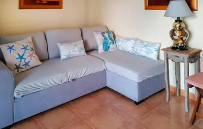 a couch and a chair in a living room at 1 Bedroom Nice Apartment In Cullera in Cullera