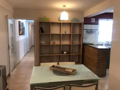 a kitchen with a table and shelves in a room at Casco antiguo, el Carmen. in Valencia