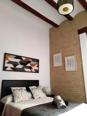 a bedroom with two beds and a ceiling at Ruzafa, centro ciudad. Terraza-wifi in Valencia