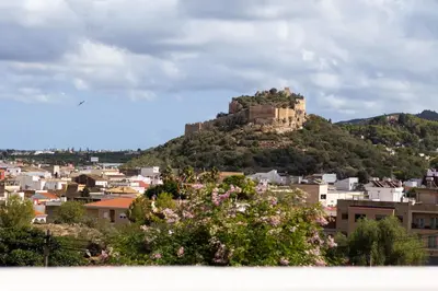 a castle on top of a hill in a city at Casa Rural La Torreta in Corbera de Alcira