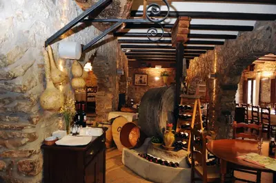 a wine tasting room with a large barrel and a table at Hotel Restaurant Verdià in Sueras