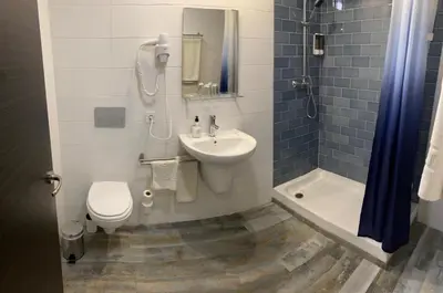 a bathroom with a sink and a toilet and a shower at Nanit Valencia Hostel in Valencia