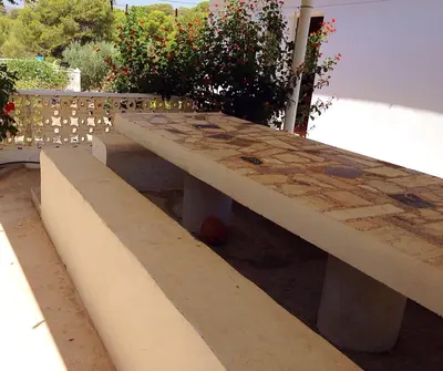 a stone bench sitting on top of a building at Chalet en el Monte con Piscina in Sagunto