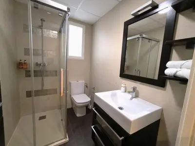 a bathroom with a toilet and a sink and a shower at FLORIT FLATS - The Jardines del Turia Apartment in Valencia