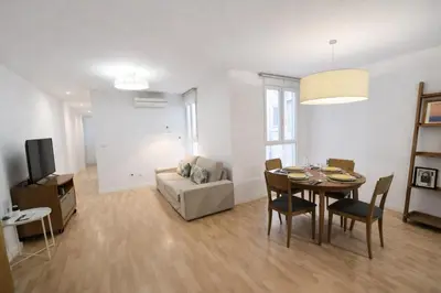 a living room with a table and a couch at FLORIT FLATS - The Jardines del Turia Apartment in Valencia