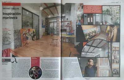 a couch in a room with paintings on the wall at Loft Valencia Playa in Valencia