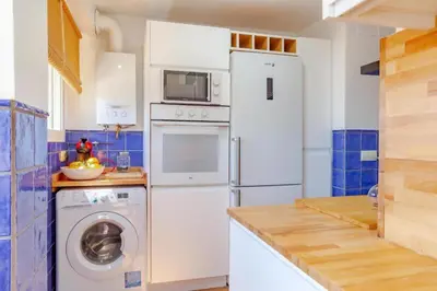 a kitchen with a white refrigerator and a washing machine at Perfecto apto a orillas del mediterráneo / 4PAX in El Perellonet