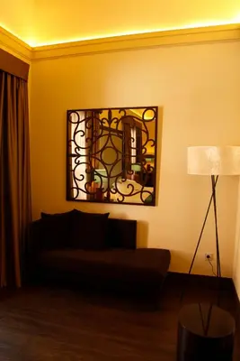 a living room with a couch and a mirror on the wall at Hotel Spa Martín el Humano in Segorbe