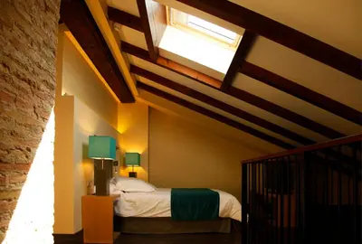 a bedroom with a bed and a ceiling with a window at Hotel Spa Martín el Humano in Segorbe