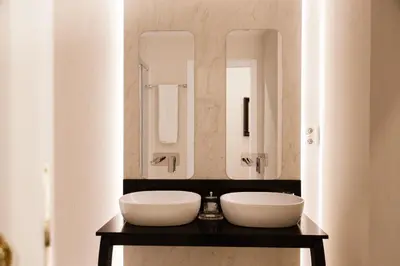 a bathroom with two sinks and mirrors on a counter at MD Julio Antonio in Valencia