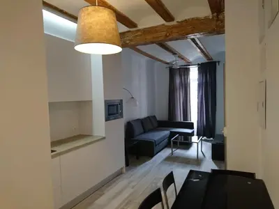 a living room with a table and a couch at NWT Central Station Apartments in Valencia