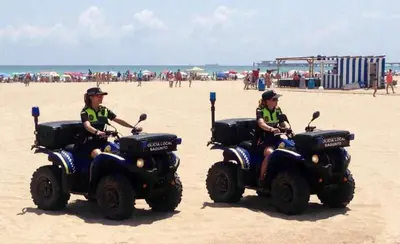 two people are riding atvs on the beach at playa y relax valencia in Puerto de Sagunto