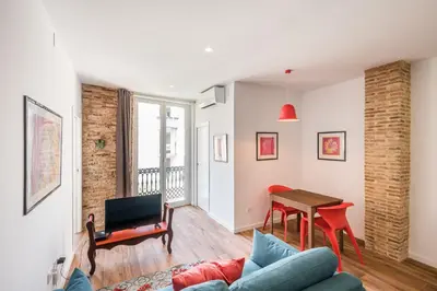 a living room with a couch and a table at L'Arbre in Valencia