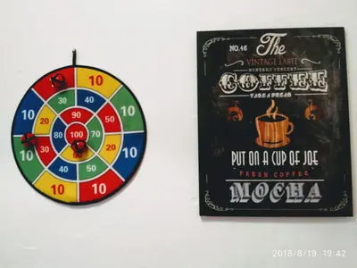a dart board and a sign with a dart wheel at Valencian Dreams of the Proletariat in Valencia