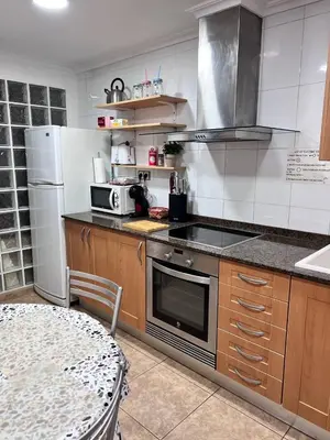 a kitchen with a stove and a table in it at Plaza Sainetero Arniches in Valencia