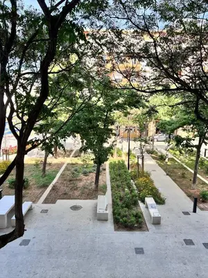 a park with benches and trees in a park at Plaza Sainetero Arniches in Valencia