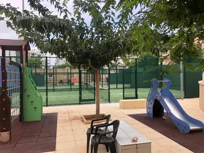 a playground with a slide and a tree at Apartamento de lujo en Canet de Berenguer a 150 m de la playa in Canet de Berenguer