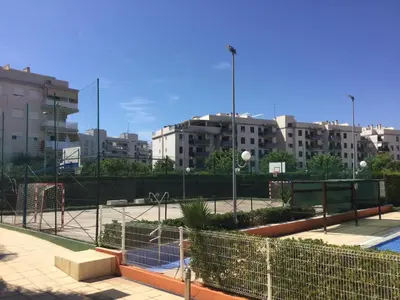 a tennis court in a city with buildings at Apartamento de lujo en Canet de Berenguer a 150 m de la playa in Canet de Berenguer
