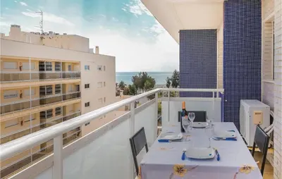 a balcony with a table and chairs on a building at Cozy Apartment In Moncófar With Wifi in Moncófar