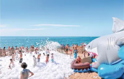 a group of people playing in the water at the beach at Cozy Apartment In Moncófar With Wifi in Moncófar