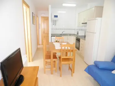 a kitchen and dining room with a table and chairs at Apartamentos rurales Benafer in Benafer