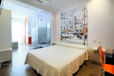 a bedroom with a bed and a painting on the wall at Hotel Boutique Sabbia Valencia in Valencia