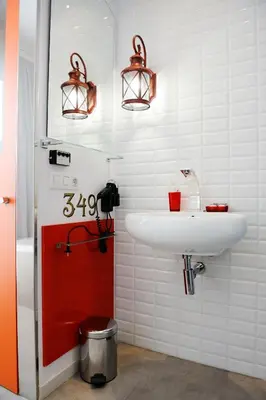 a bathroom with a sink and a red door at Hotel Boutique Sabbia Valencia in Valencia