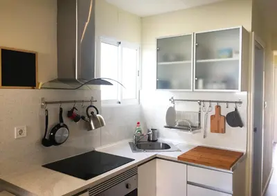 a kitchen with a sink and a counter top at Ático cerca del mar in Valencia