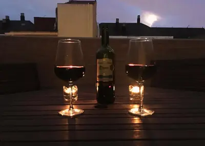 a bottle of wine and two glasses on a table at Ático cerca del mar in Valencia