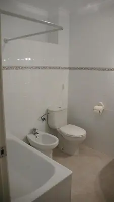 a bathroom with a toilet and a sink and a bath tub at Apartamento Portalet 7 in Benaguacil