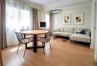 a living room with a table and chairs and a couch at TTdSSa VLC Plaza Cisneros in Valencia