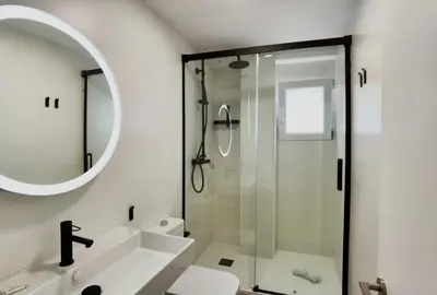 a bathroom with a shower and a sink and a mirror at TTdSSa VLC Plaza Cisneros in Valencia