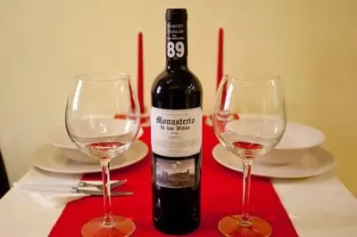 a bottle of wine and two wine glasses on a table at Apartament in historic center in Valencia
