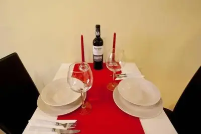 a red table with two glasses and a bottle of wine at Apartament in historic center in Valencia