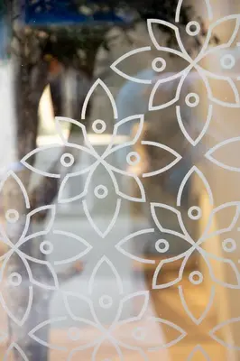 a glass window with a flower pattern on it at Hotel Alkazar in Valencia