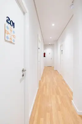 an empty hallway with white walls and wood floors at Hotel Alkazar in Valencia