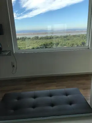 a large window with a couch in front of it at Gran Apartamento, un lujo en playa El Saler - Valencia in El Saler