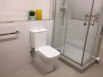a white bathroom with a toilet and a shower at KOA Centric, comfy in Ruzafa in Valencia