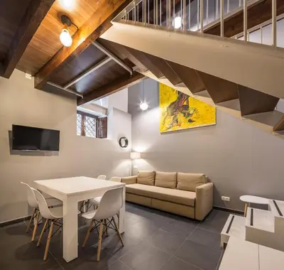a living room with a table and a couch at Catalina Suites San Nicolas in Valencia