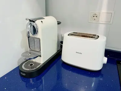 a toaster sitting on a blue counter in a kitchen at Apartamento Nuevo con Gran Terraza y Wifi en Canet in Canet de Berenguer