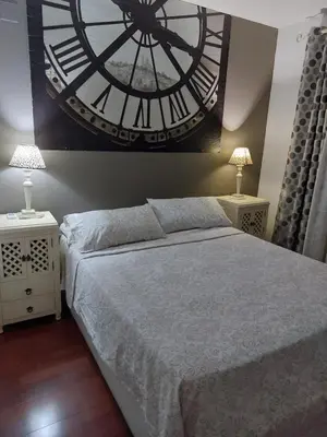 a bedroom with a large clock on the wall at Bonito piso 4 habitaciones en Bétera in Bétera