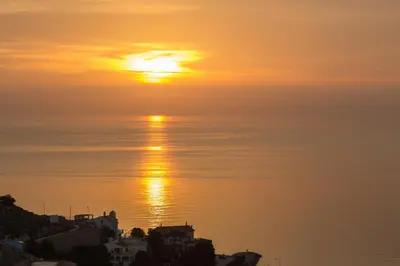 a sunset over the ocean with the sun in the sky at Cap Blanc Penthouse in Cullera